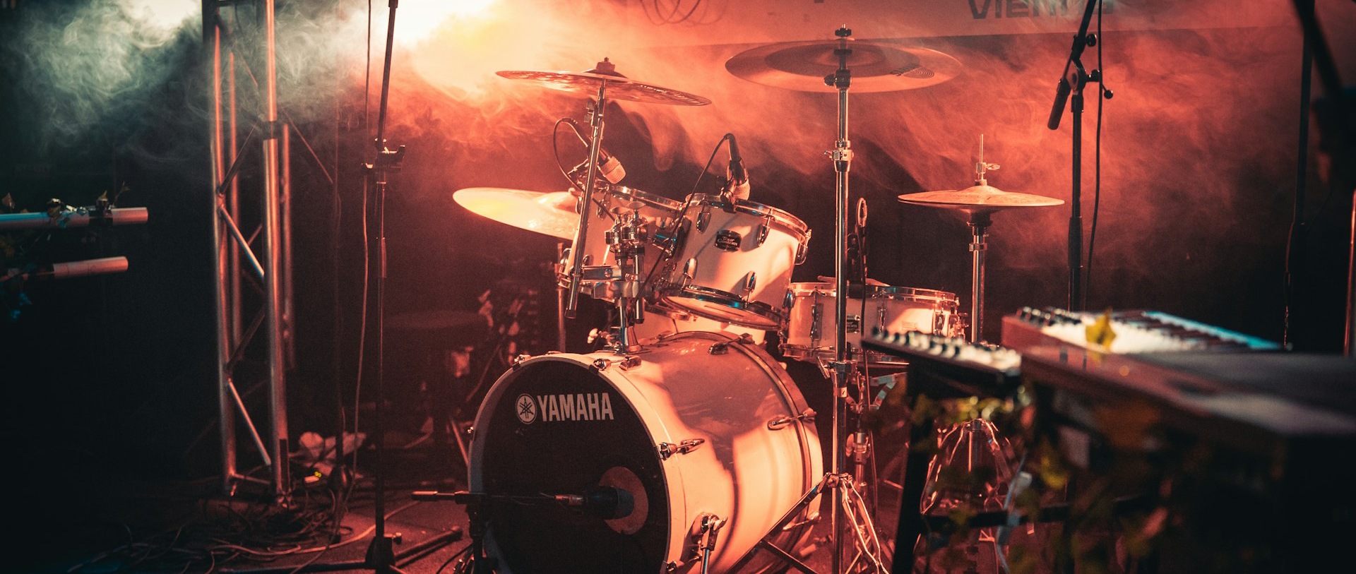 Yamaha drum kit and stage backline under concert lighting