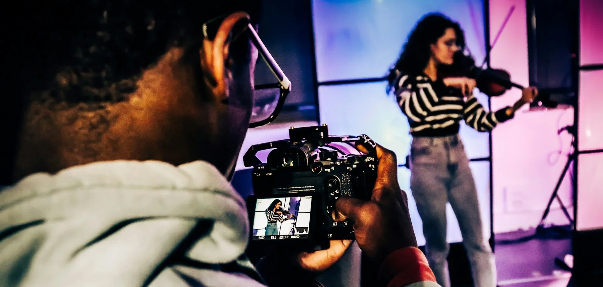 Cameraman filming a violinist for an audition or showreel recording