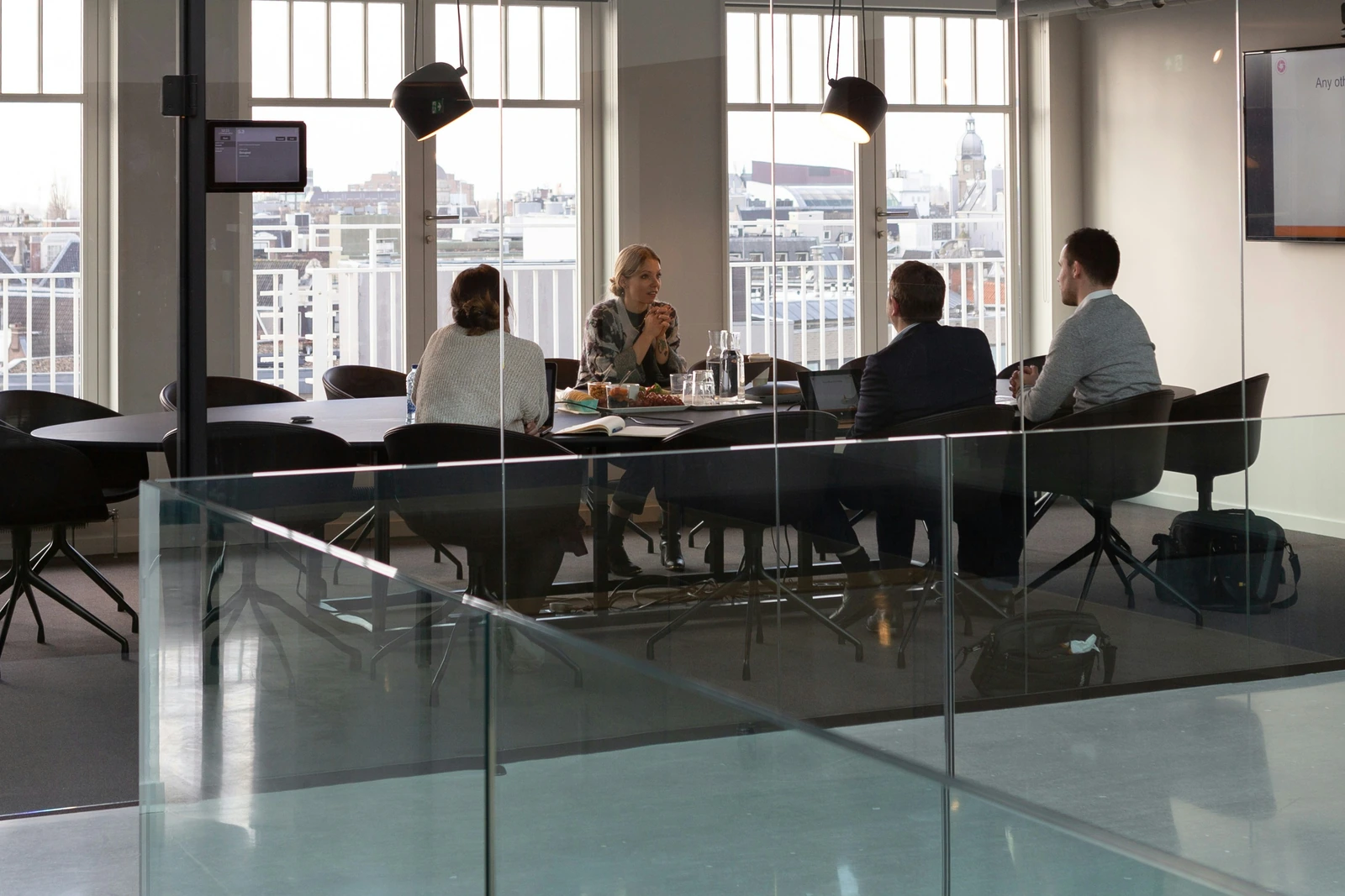 Business team meeting in a glass-walled conference room