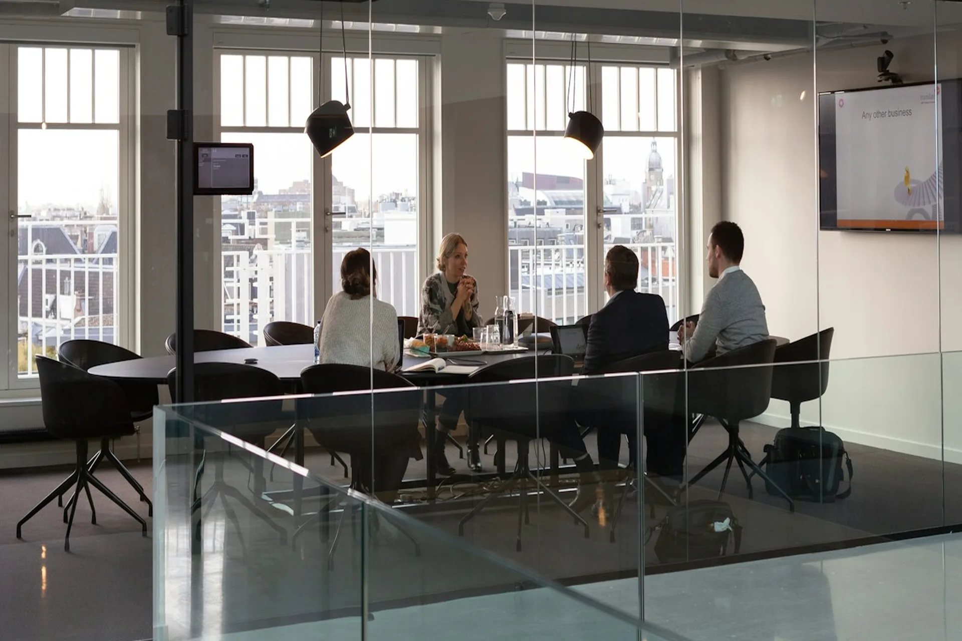 Business team meeting in a glass-walled conference room